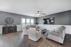 living area with a ceiling fan and wood finished floors