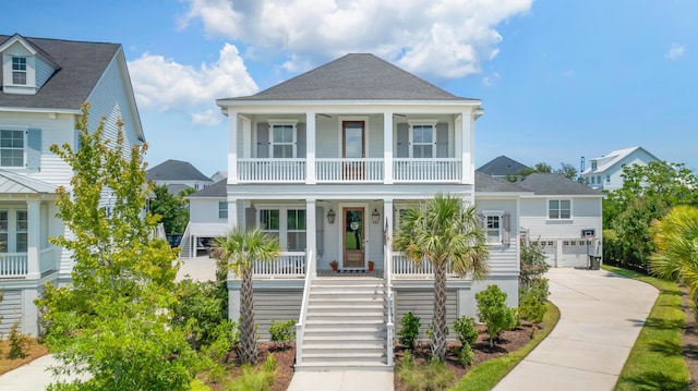 1722 Trewin Ct, Charleston, SC 29492 - raised beach house featuring a porch, stairs, driveway, a shingled roof, and a balcony