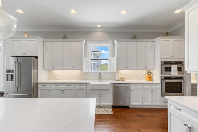 1722 Trewin Ct, Charleston, SC 29492 - kitchen with stainless steel appliances, white cabinets, ornamental molding, tasteful backsplash, and dark wood-style floors
