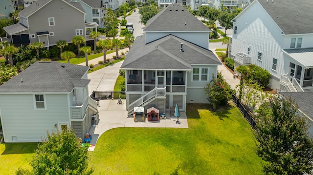 1722 Trewin Ct, Charleston, SC 29492 - back of house featuring a sunroom, a patio, a residential view, and a shingled roof