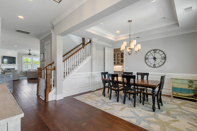 1722 Trewin Ct, Charleston, SC 29492 - dining area with a chandelier, stairs, crown molding, a ceiling fan, and wood finished floors