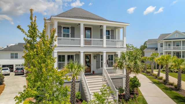 1722 Trewin Ct, Charleston, SC 29492 - coastal inspired home featuring a porch, a balcony, a ceiling fan, stairway, and driveway