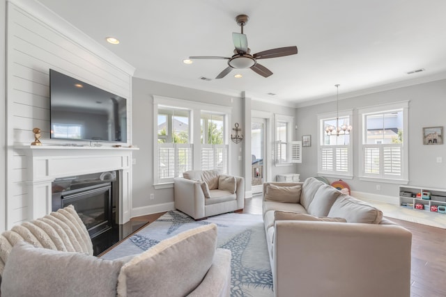 1722 Trewin Ct, Charleston, SC 29492 - living area featuring crown molding, wood finished floors, a glass covered fireplace, a ceiling fan, and recessed lighting