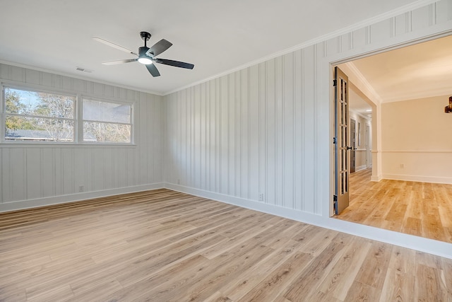 unfurnished room featuring ornamental molding, ceiling fan, and light hardwood / wood-style flooring