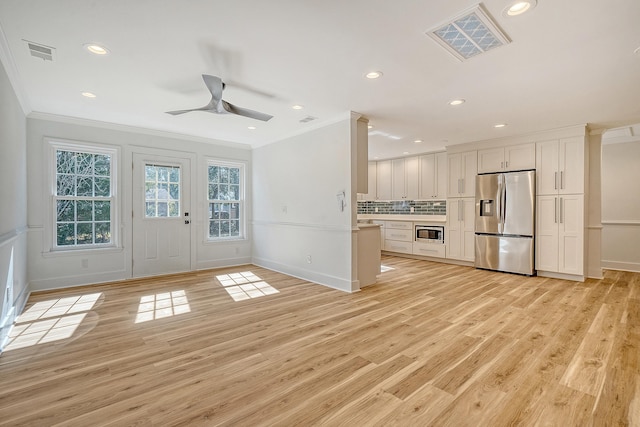 unfurnished living room with light hardwood / wood-style flooring, ornamental molding, and ceiling fan