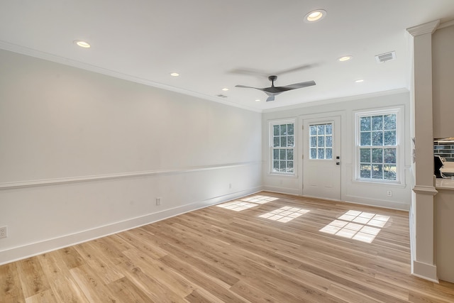 empty room with ornamental molding, ceiling fan, and light hardwood / wood-style flooring