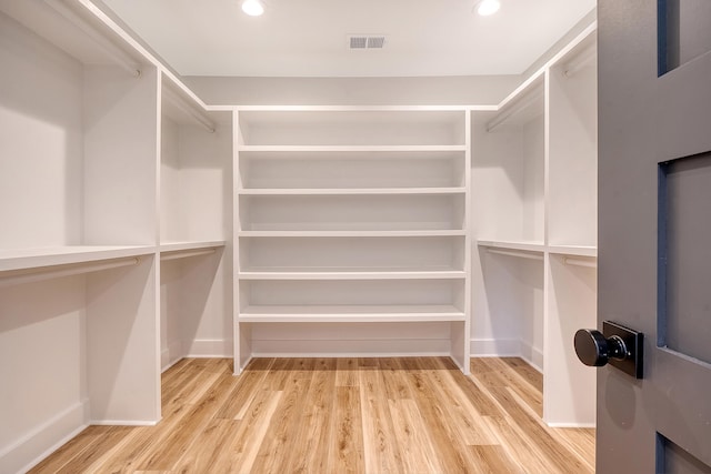 walk in closet with light wood-type flooring