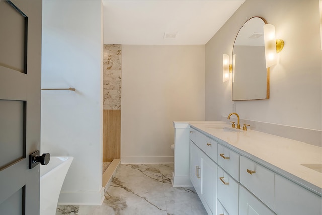 bathroom with vanity, a tub to relax in, and toilet