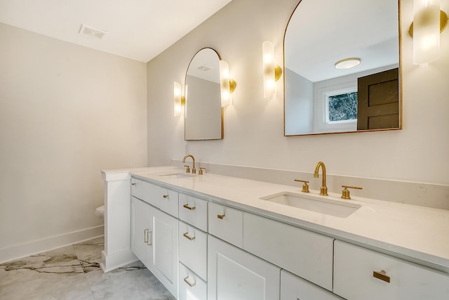 bathroom featuring vanity and toilet