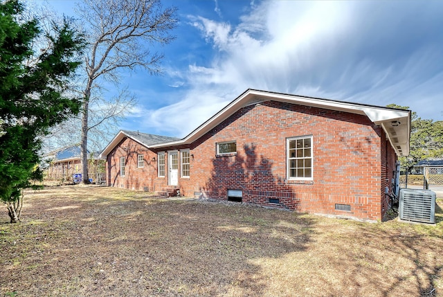 back of property featuring central AC