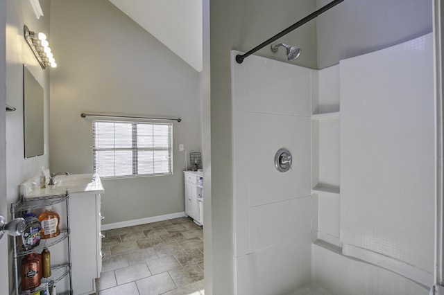 bathroom with a shower, vanity, and lofted ceiling