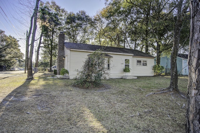 view of side of home with a lawn