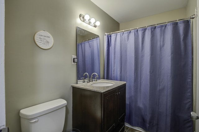 bathroom featuring toilet and vanity