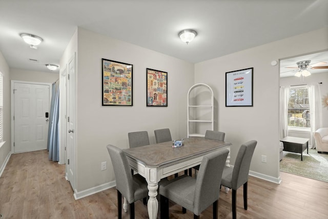 dining room featuring light wood-type flooring and ceiling fan