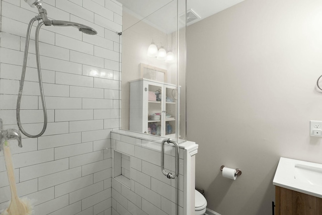 bathroom with vanity, toilet, and an enclosed shower