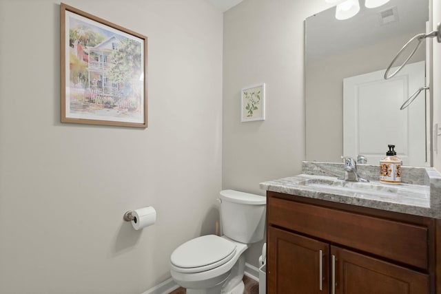 bathroom featuring vanity and toilet