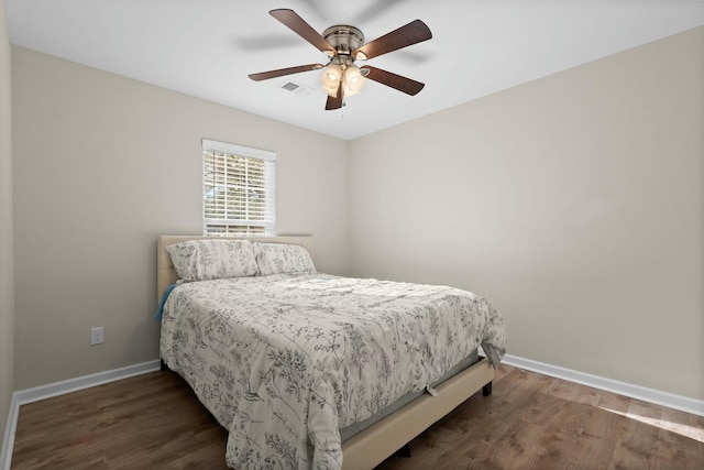 bedroom featuring ceiling fan and dark wood-type flooring