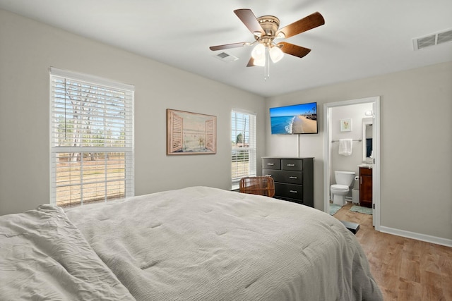 bedroom with ensuite bathroom, ceiling fan, and light hardwood / wood-style floors