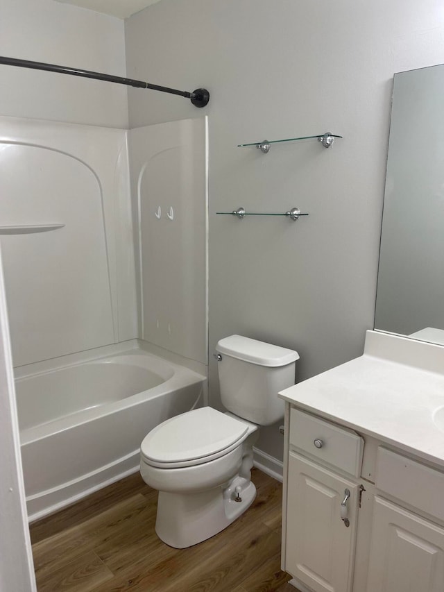 full bathroom with toilet, bathtub / shower combination, vanity, and hardwood / wood-style flooring