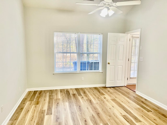 empty room featuring ceiling fan, lofted ceiling, and light hardwood / wood-style floors