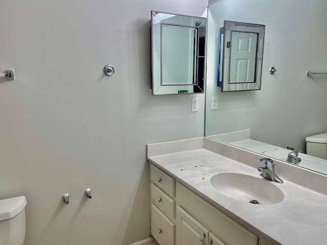 bathroom featuring toilet and large vanity