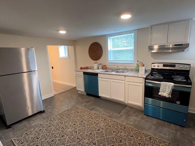 kitchen with white cabinetry, sink, dark parquet floors, and appliances with stainless steel finishes