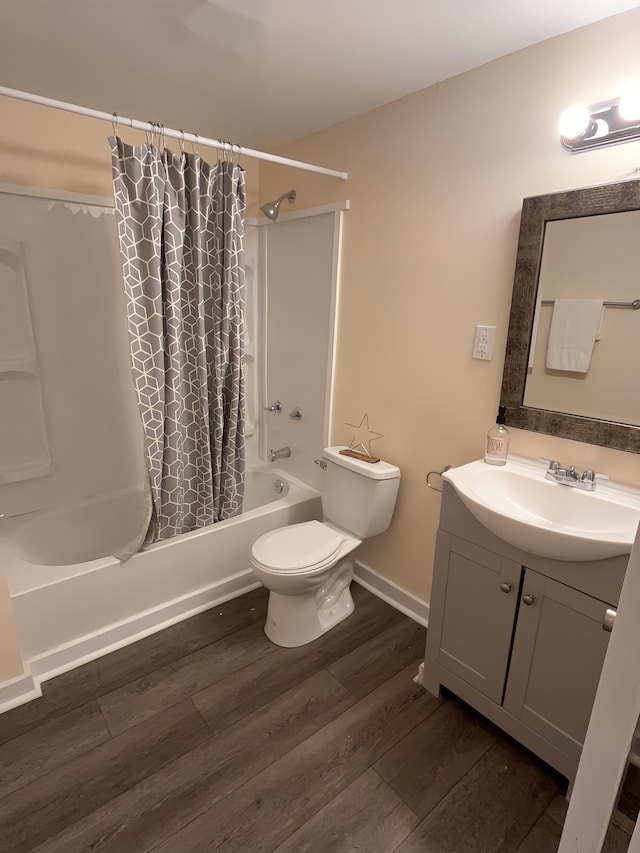 full bathroom with hardwood / wood-style floors, vanity, toilet, and shower / bathtub combination with curtain