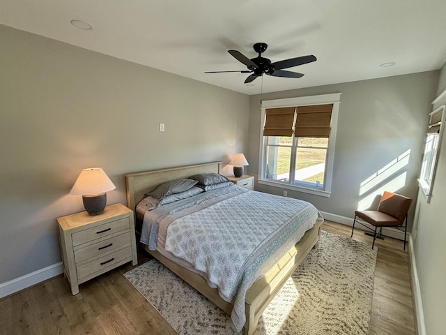 bedroom with light hardwood / wood-style flooring and ceiling fan