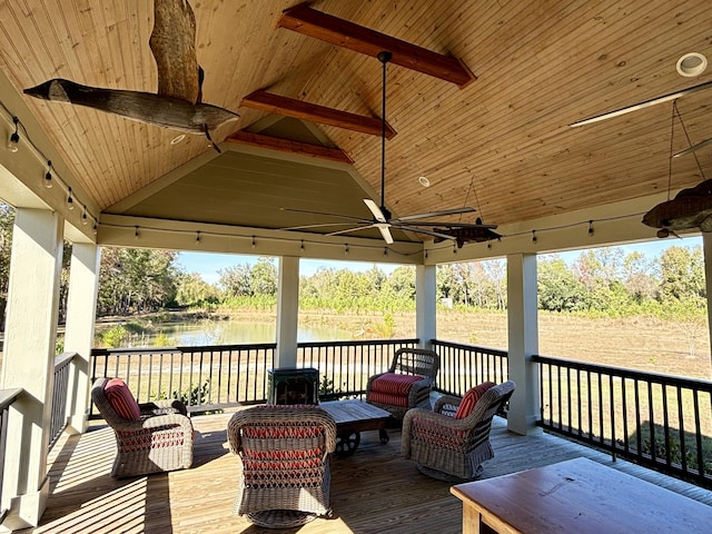 wooden terrace featuring a gazebo, an outdoor hangout area, a water view, and ceiling fan