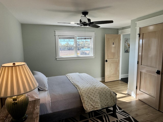 bedroom with ceiling fan and light hardwood / wood-style flooring