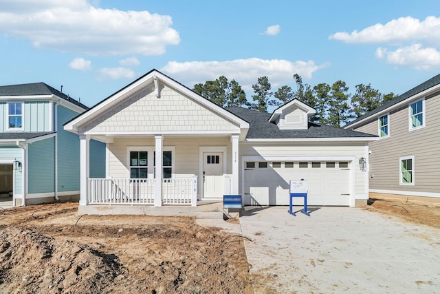 316 Calm Water Way, Summerville, SC 29486 - view of front facade featuring covered porch, a garage, driveway, and roof with shingles