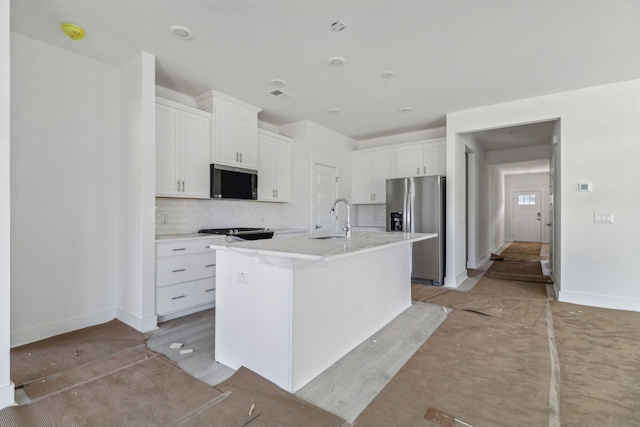 316 Calm Water Way, Summerville, SC 29486 - kitchen featuring appliances with stainless steel finishes, a sink, white cabinetry, decorative backsplash, and an island with sink