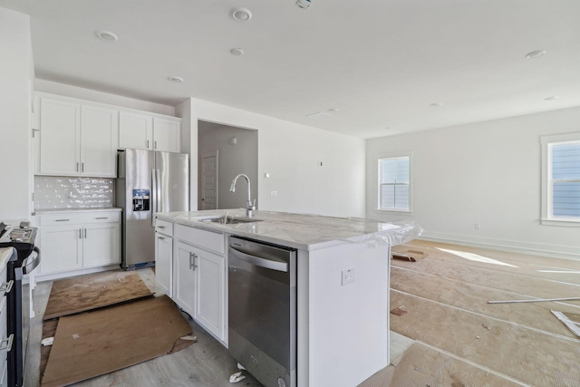 316 Calm Water Way, Summerville, SC 29486 - kitchen featuring appliances with stainless steel finishes, a sink, light stone countertops, a kitchen island with sink, and white cabinetry