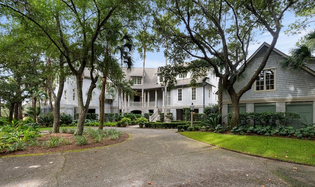 view of front of home featuring a front lawn and a sunroom