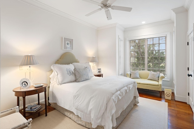 bedroom with hardwood / wood-style flooring, ceiling fan, and crown molding