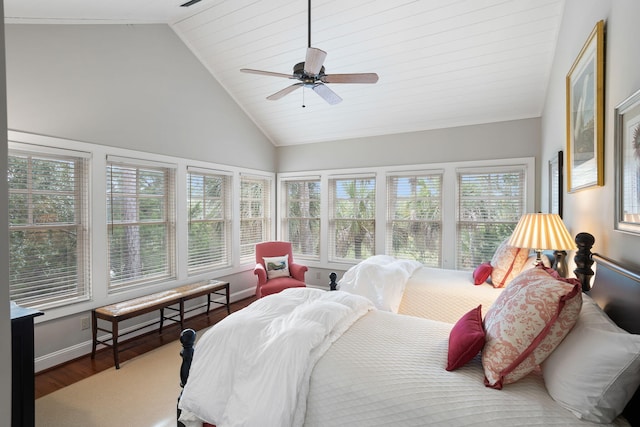 bedroom featuring hardwood / wood-style floors, high vaulted ceiling, and ceiling fan