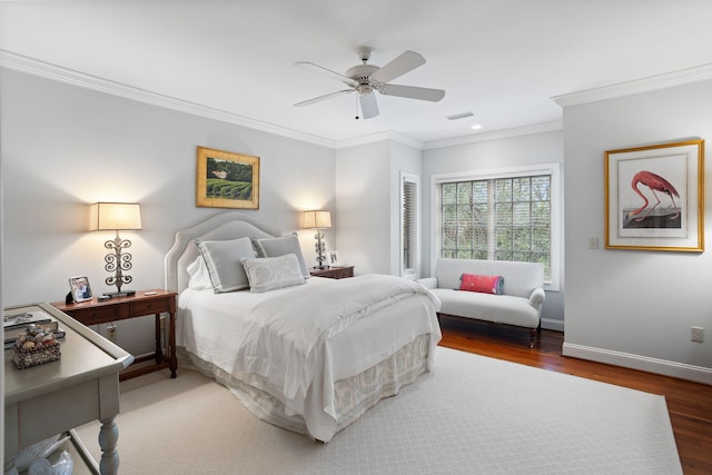 bedroom featuring hardwood / wood-style floors, crown molding, and ceiling fan