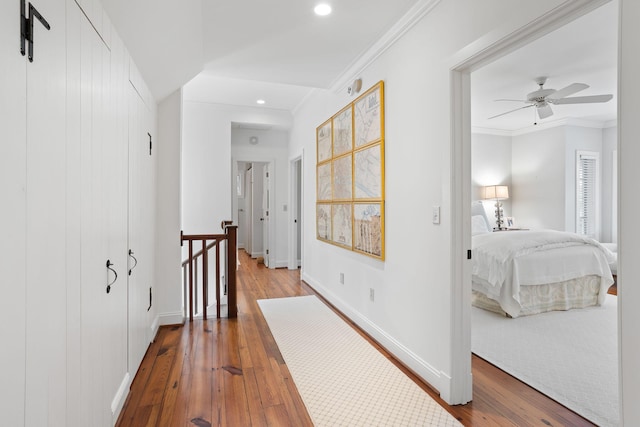 corridor with crown molding and light wood-type flooring