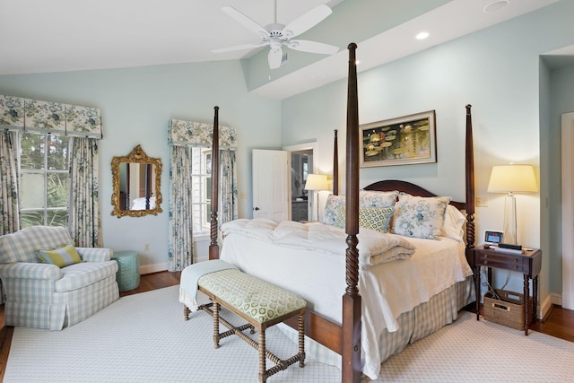 bedroom featuring multiple windows, vaulted ceiling, and light hardwood / wood-style floors