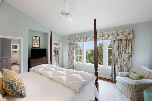 bedroom featuring ceiling fan, connected bathroom, vaulted ceiling, and light wood-type flooring