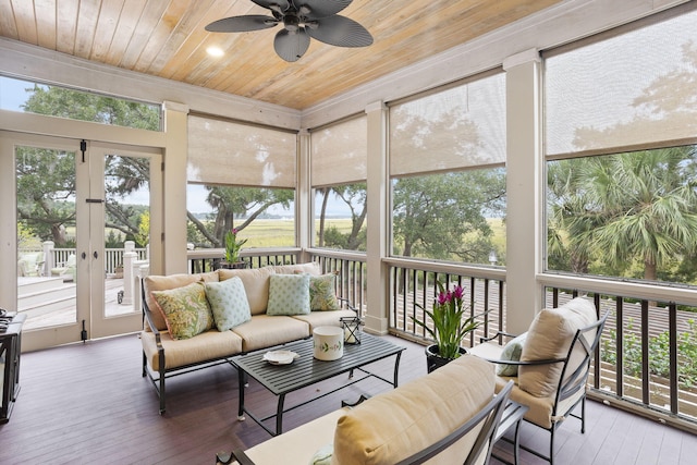 sunroom with ceiling fan and wood ceiling