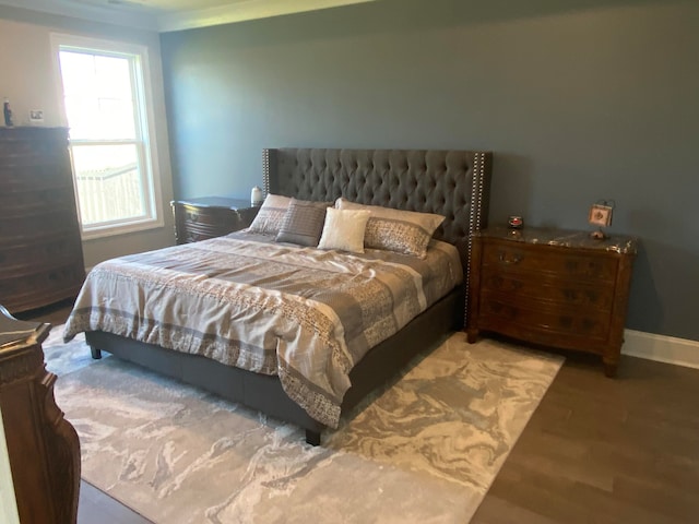 bedroom featuring ornamental molding and hardwood / wood-style floors