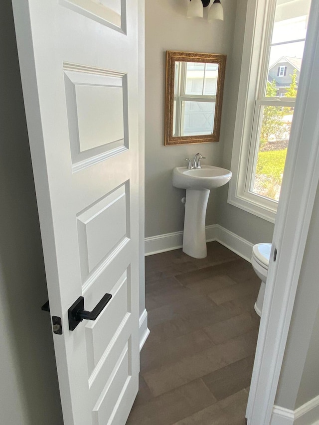 bathroom featuring hardwood / wood-style flooring and toilet