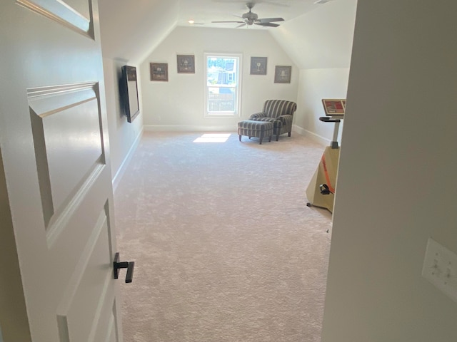 additional living space featuring light carpet, vaulted ceiling, and ceiling fan