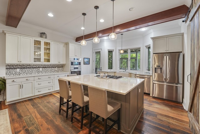 1193 River Rd, Johns Island, SC 29455 - kitchen with stainless steel appliances, ornamental molding, tasteful backsplash, a breakfast bar area, and glass insert cabinets