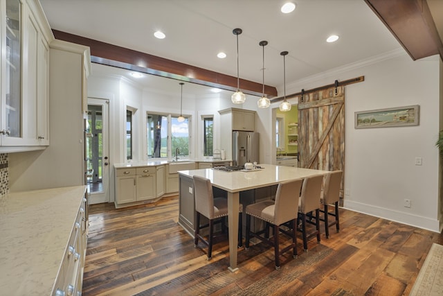 1193 River Rd, Johns Island, SC 29455 - dining room with dark wood finished floors, a barn door, ornamental molding, recessed lighting, and baseboards