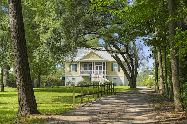 1193 River Rd, Johns Island, SC 29455 - view of front of property with dirt driveway, stairs, a front lawn, and a sunroom