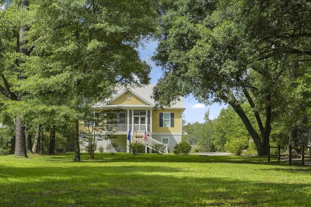 1193 River Rd, Johns Island, SC 29455 - view of front of property with stairway, a sunroom, and a front yard