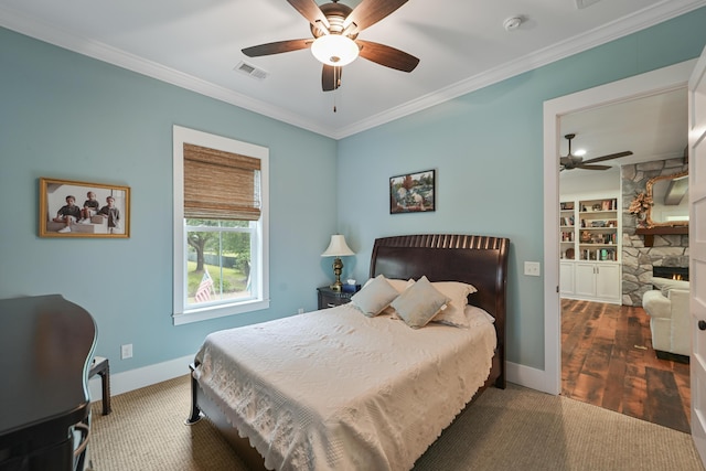 1193 River Rd, Johns Island, SC 29455 - bedroom featuring crown molding, baseboards, wood finished floors, a ceiling fan, and a fireplace