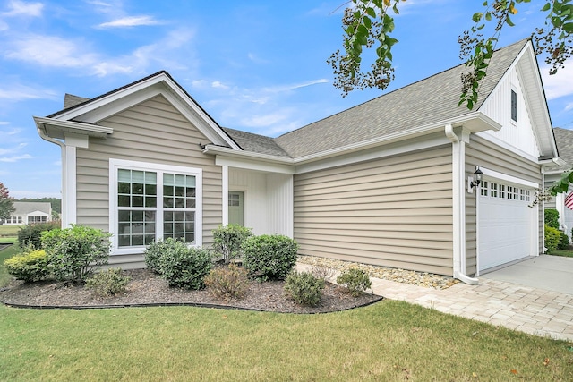 view of front of home with a garage and a front yard